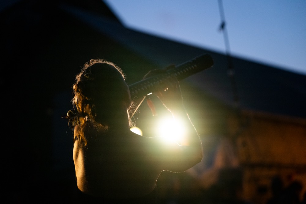 Sofie playing the Aeolynth, backlit at dusk